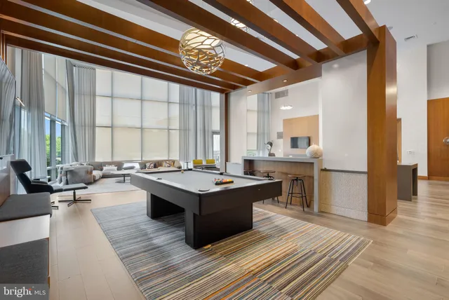 a living room with furniture and large windows