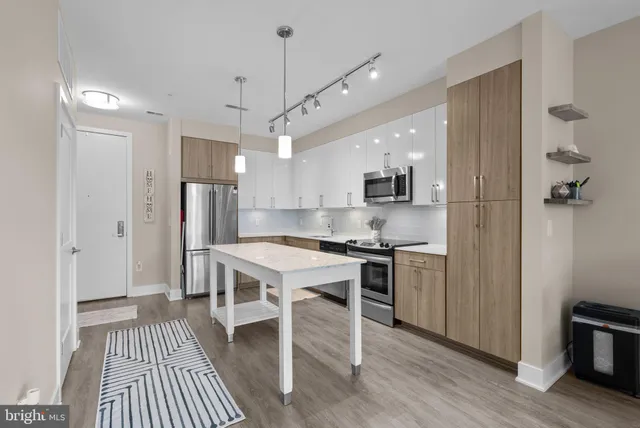 a kitchen with stainless steel appliances a stove a refrigerator and a refrigerator