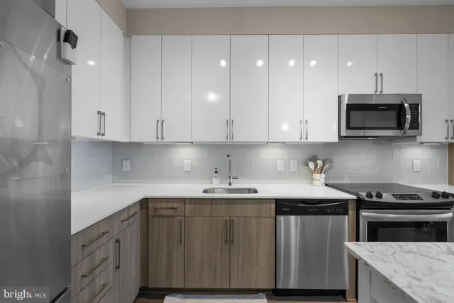 a kitchen with stainless steel appliances granite countertop a sink stove microwave and cabinets