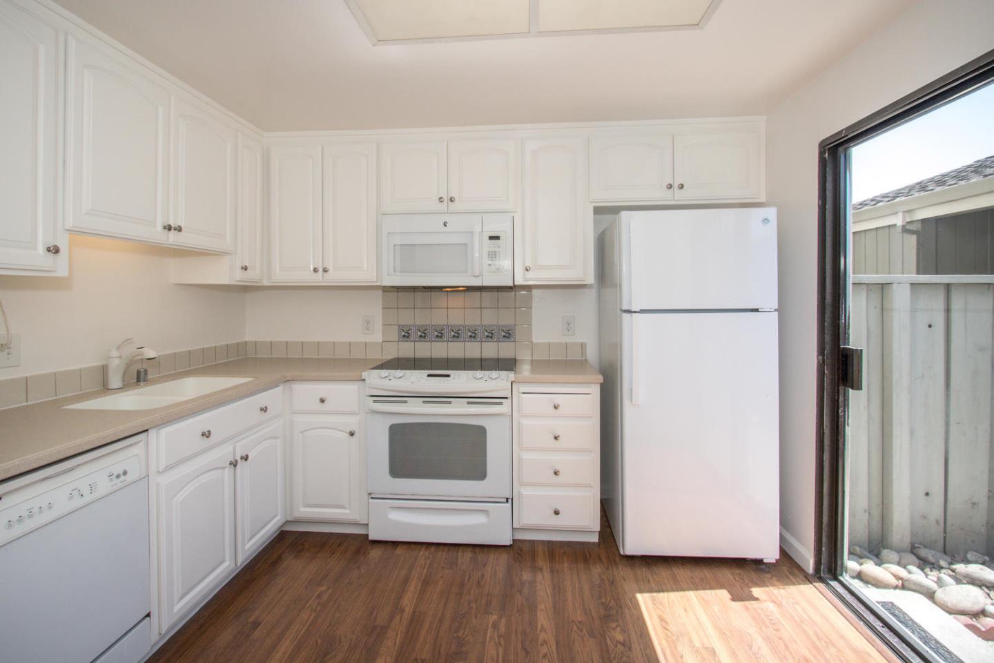 810 Juno Lane Foster City, CA 94404 - Photo 11 of 43 a kitchen with cabinets appliances and wooden floor