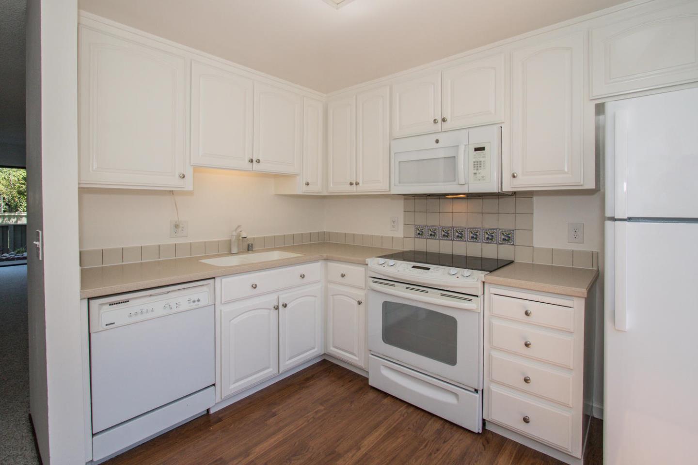 810 Juno Lane Foster City, CA 94404 - Photo 12 of 43 a kitchen with white cabinets white stainless steel appliances and sink