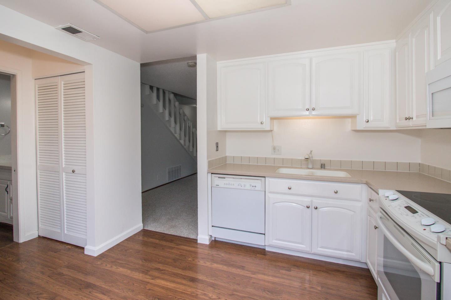 810 Juno Lane Foster City, CA 94404 - Photo 14 of 43 a kitchen with granite countertop white cabinets and white appliances