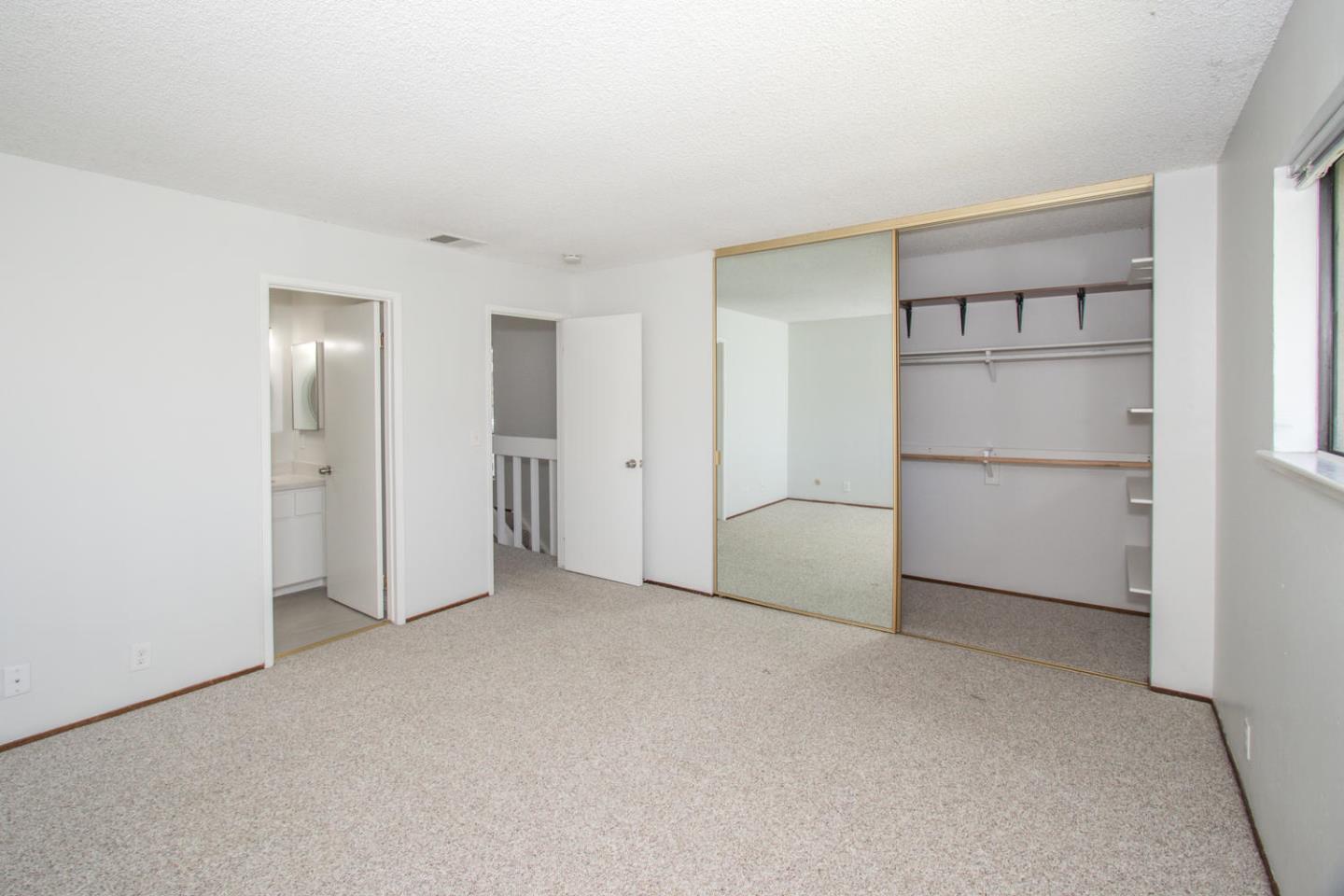 810 Juno Lane Foster City, CA 94404 - Photo 27 of 43 a view of an empty room with a cabinet and mirrors