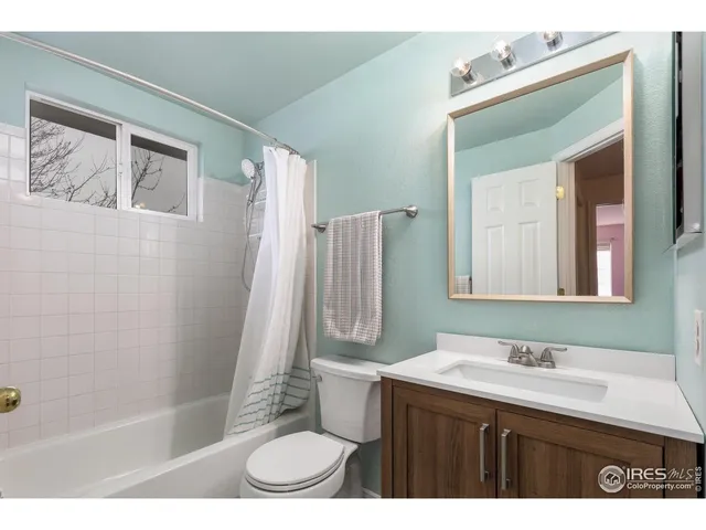 a bedroom with a bed and a night stand