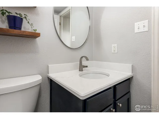 a bathroom with a toilet a sink and a mirror