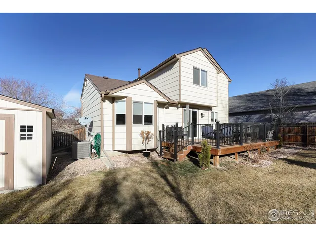 a view of a house with wooden deck and furniture