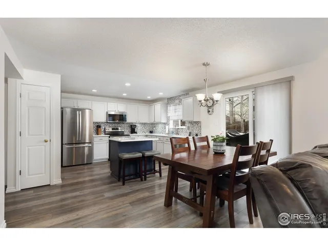 a living room with furniture wooden floor and a flat screen tv