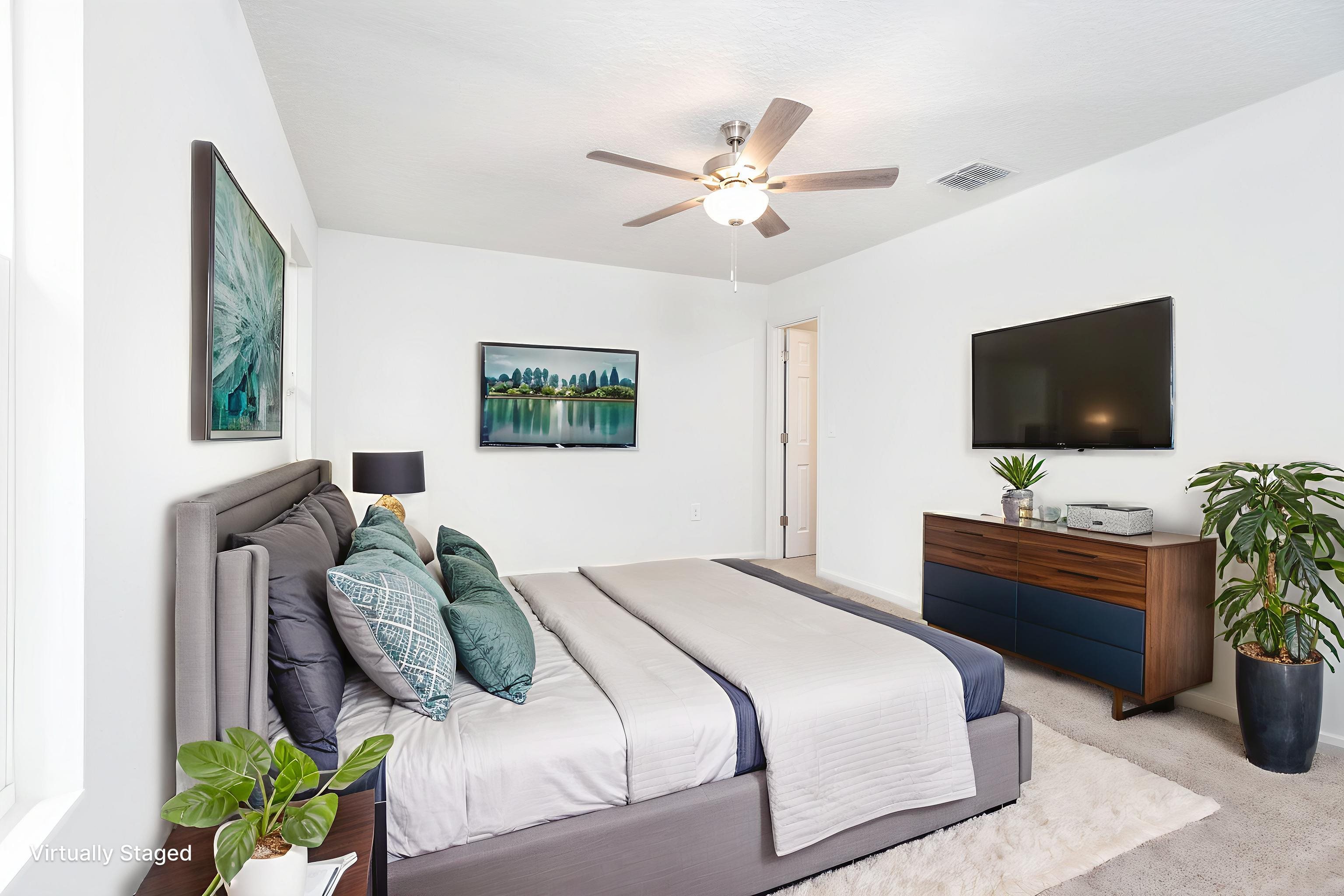 863 West 5th Street St. Augustine, FL 32084 - Photo 13 of 22 a bedroom with a bed and a flat screen tv