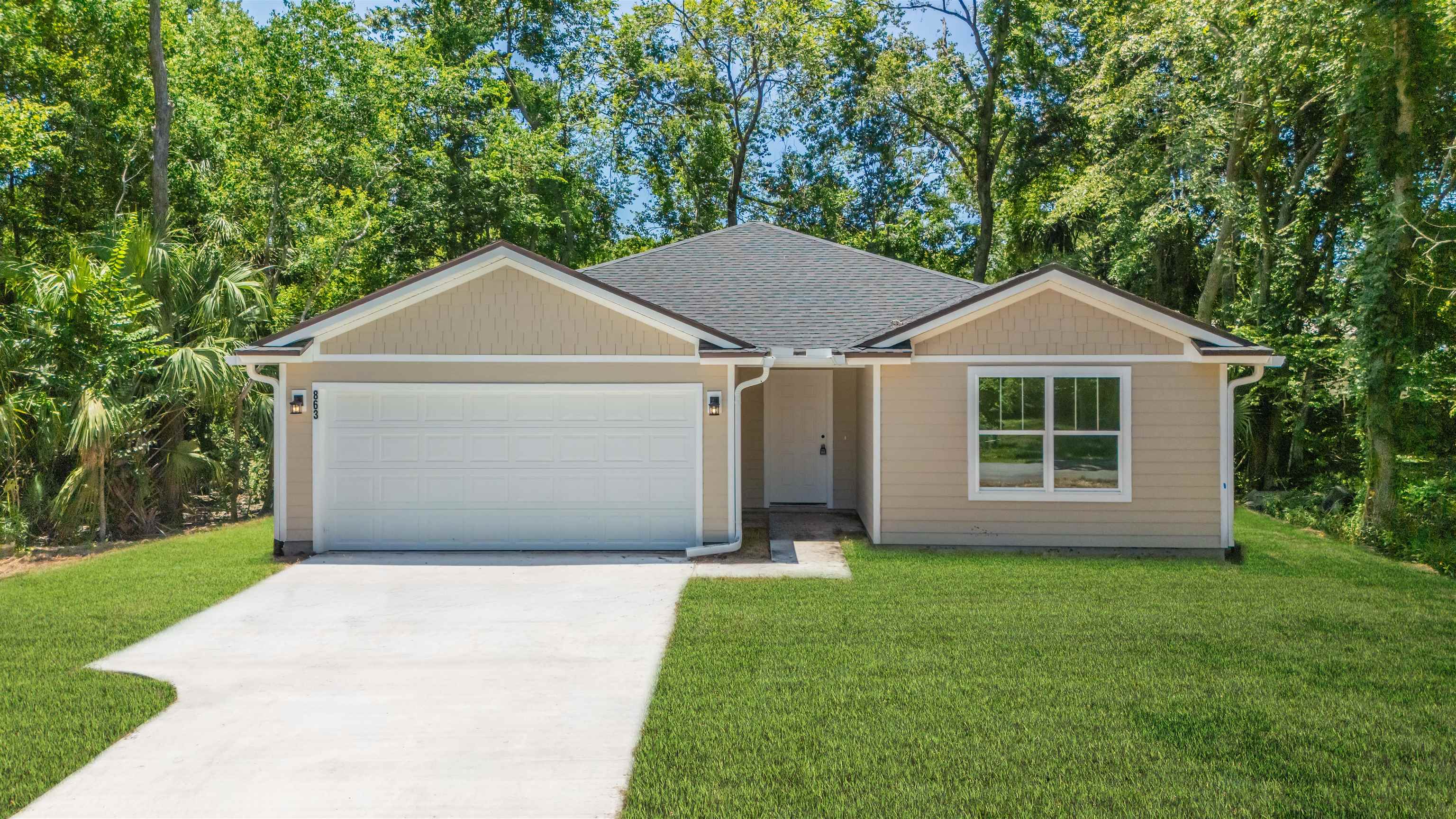 863 West 5th Street St. Augustine, FL 32084 - Photo 18 of 22 a front view of a house with a yard and garage