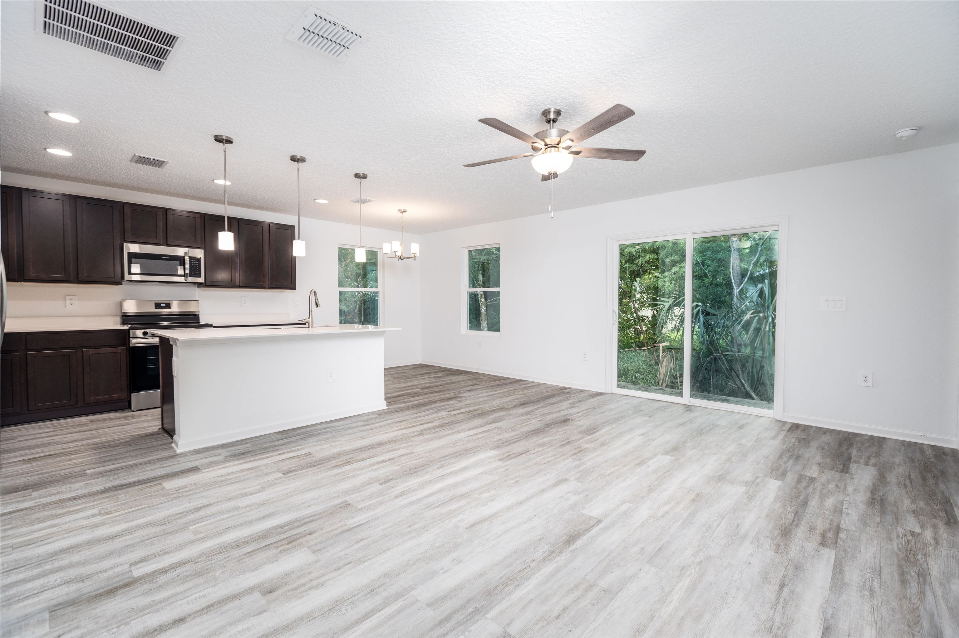 863 West 5th Street St. Augustine, FL 32084 - Photo 6 of 22 a view of a kitchen with a sink a refrigerator and window