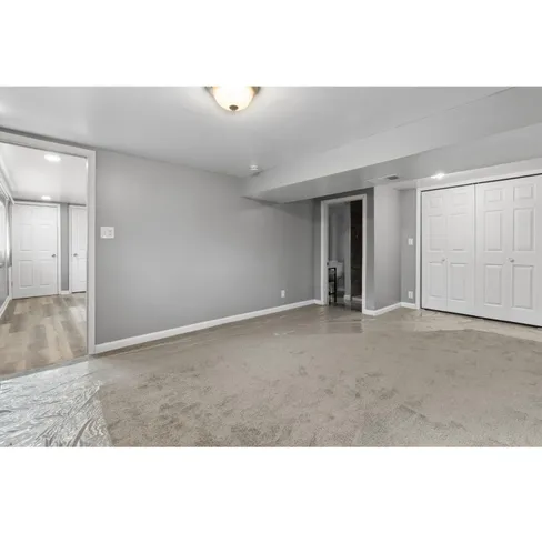 a bedroom with a bed and a large mirror