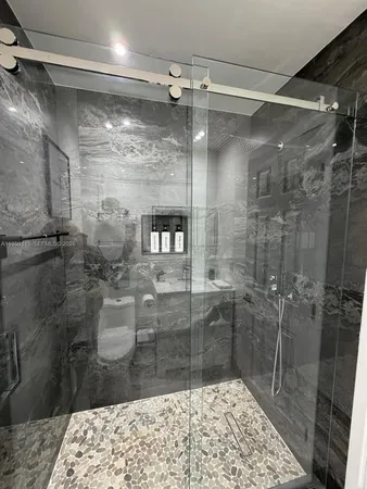 a bathroom with a shower and a sink