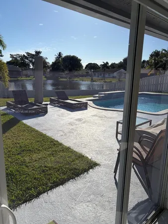 a view of a balcony with floor to ceiling windows