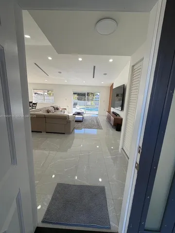 a view of living room with furniture and a rug