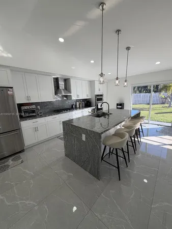 a large kitchen with lots of counter space and stainless steel appliances