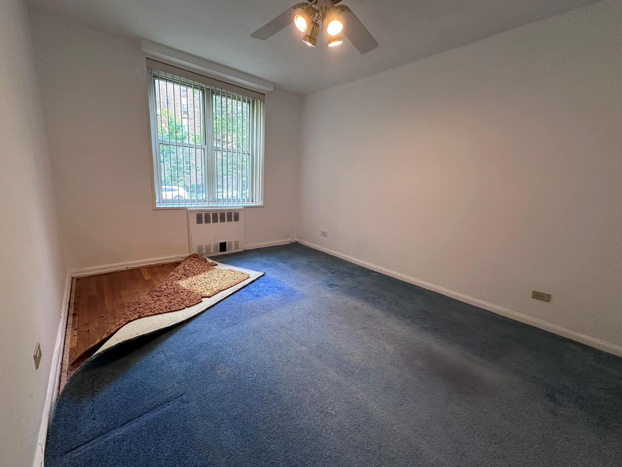 209-25 18th Avenue, Unit 1C Queens, NY 11360 - Photo 13 of 26 an empty room with a window