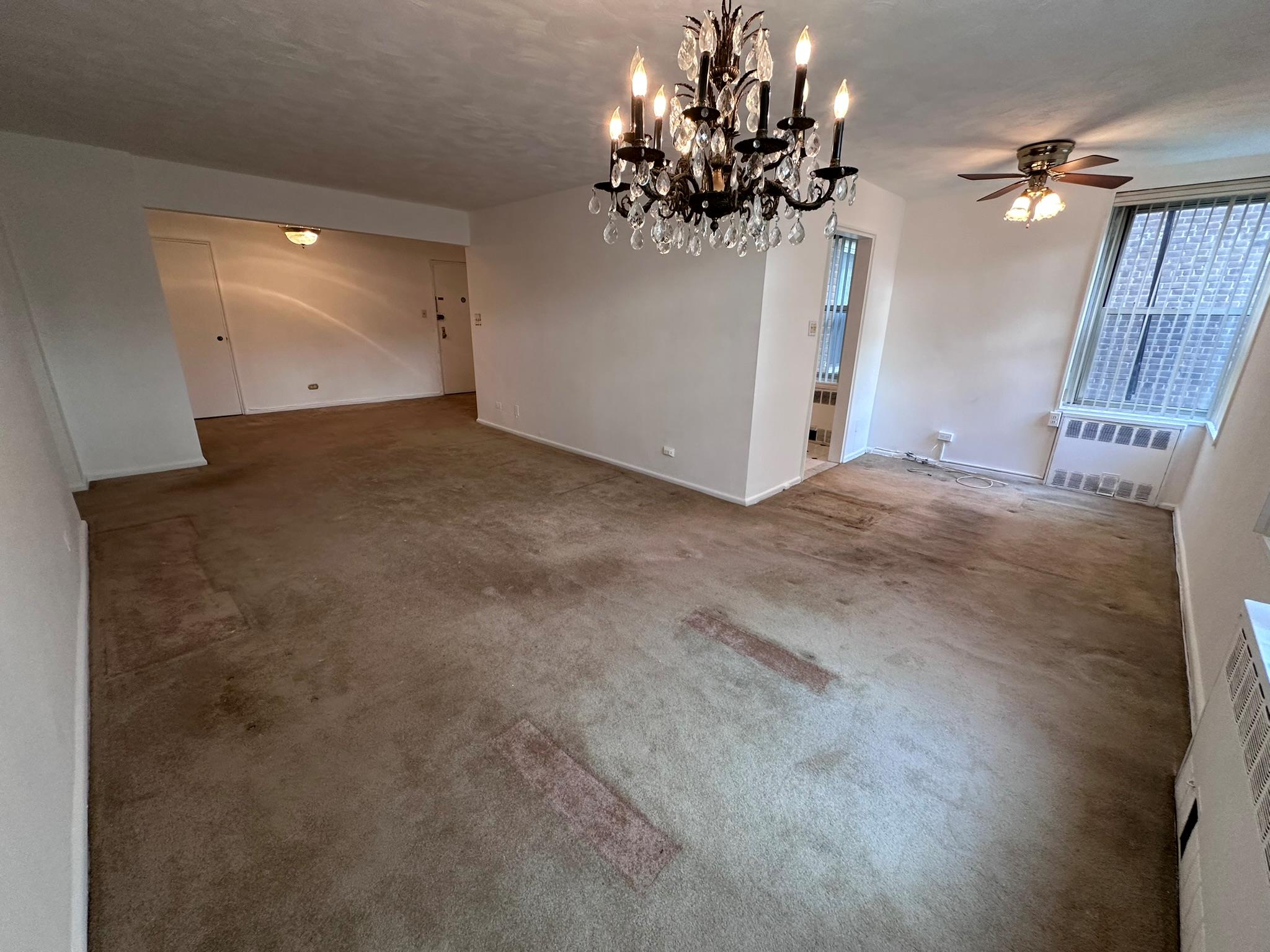 209-25 18th Avenue, Unit 1C Queens, NY 11360 - Photo 17 of 26 a view of a livingroom with a chandelier