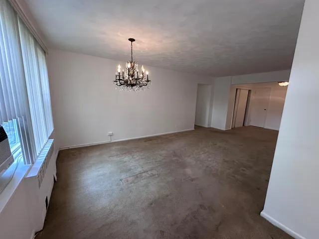 a view of an empty room with a chandelier