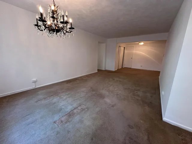 an empty room with a chandelier