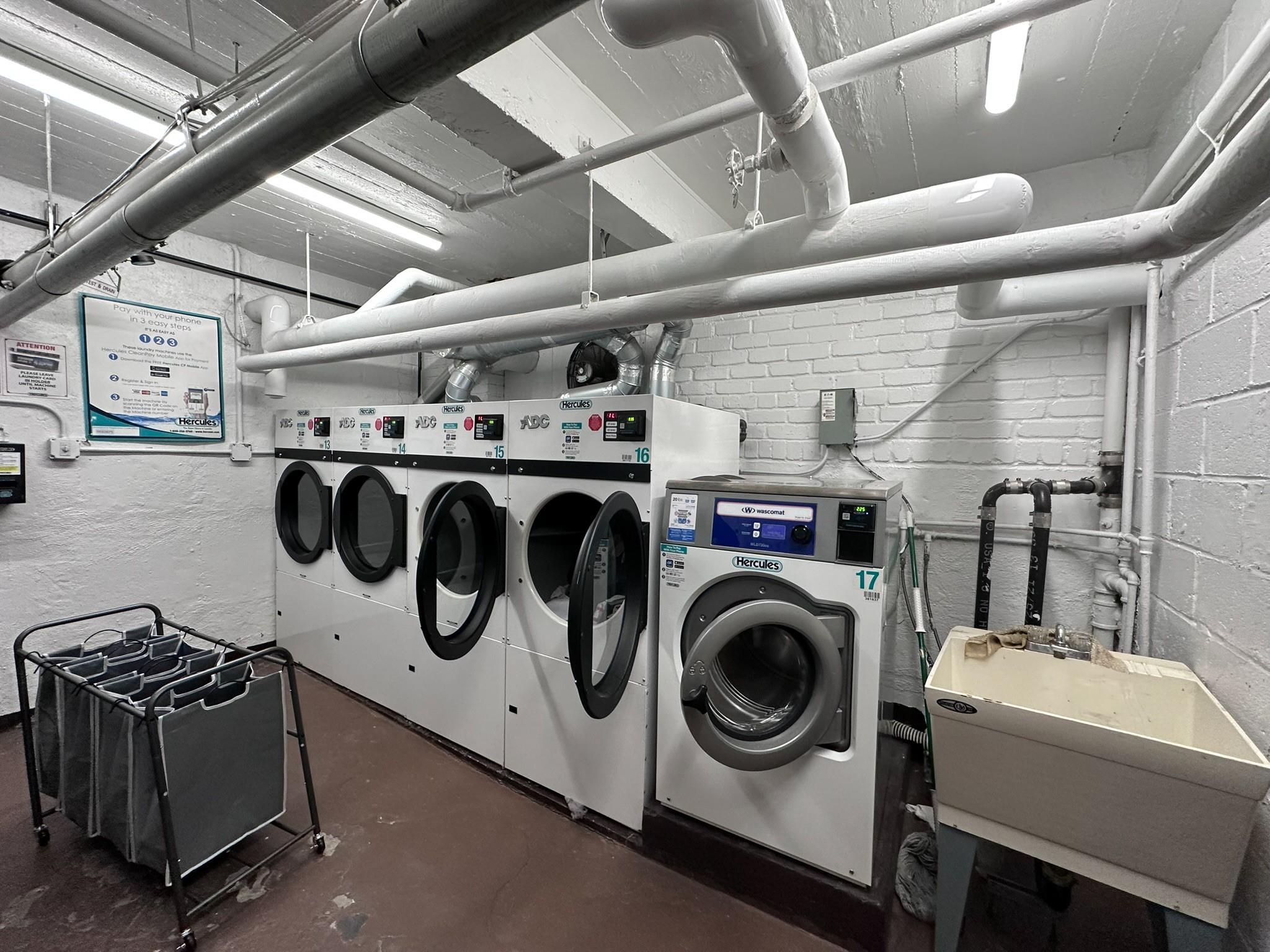 209-25 18th Avenue, Unit 1C Queens, NY 11360 - Photo 23 of 26 a utility room with dryer washer and a view of kitchen