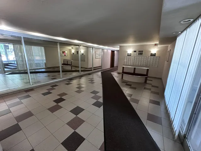 a lobby with furniture and floor to ceiling window