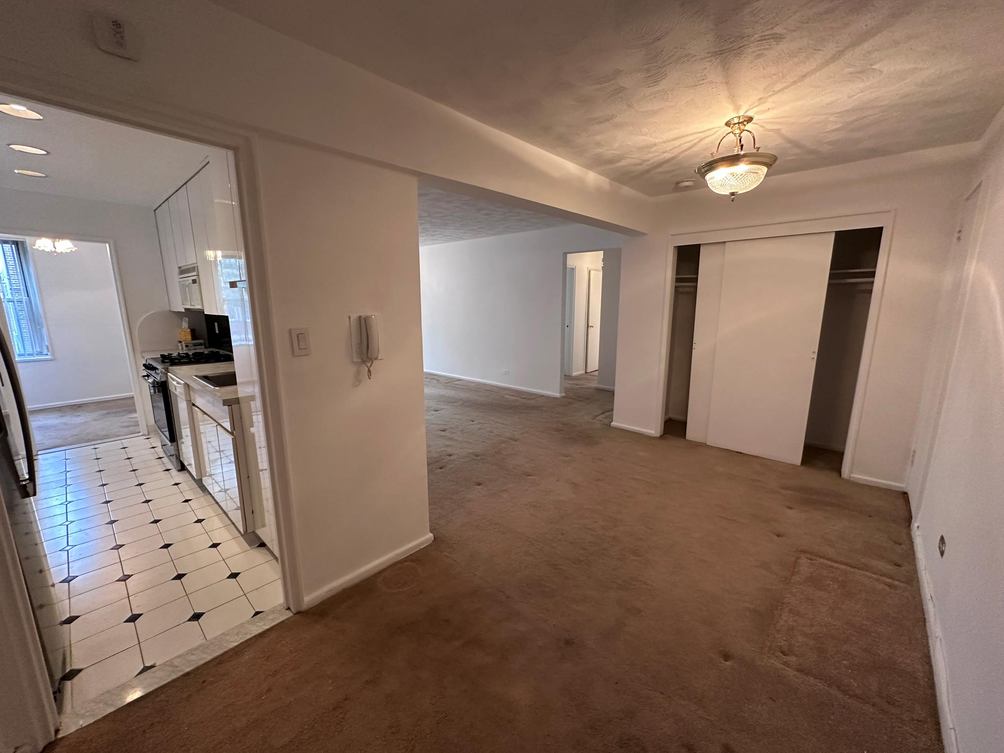 209-25 18th Avenue, Unit 1C Queens, NY 11360 - Photo 4 of 26 wooden floor in an empty room with a mirror