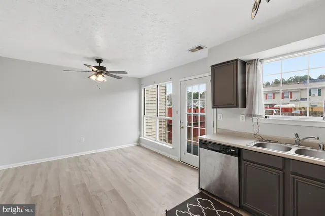 a kitchen with a sink appliances and cabinets