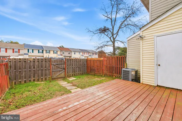 a view of a backyard with wooden fence