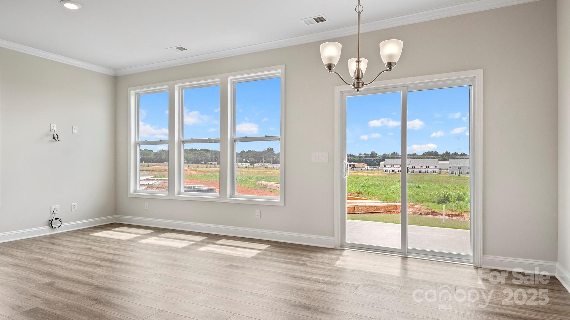 369 Creekview Road Hendersonville, NC 28792 - Photo 11 of 28 a view of an empty room with wooden floor and a window