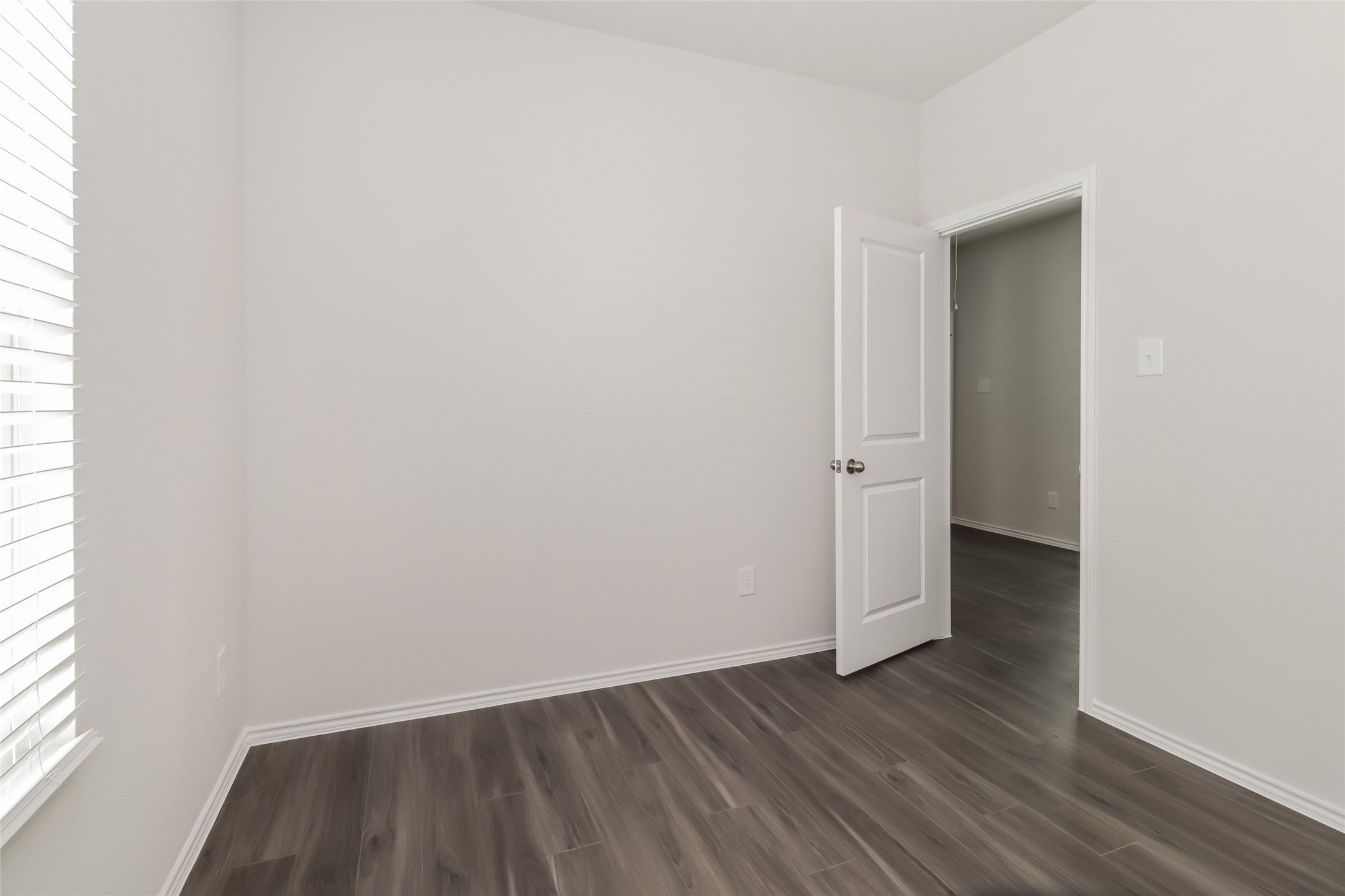 15316 Estrella Road East Houston, TX 77073 - Photo 12 of 15 an empty room with wooden floor and windows