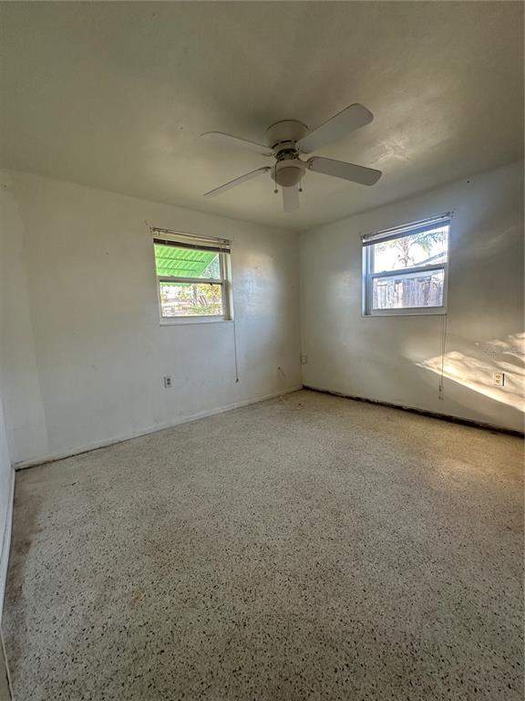 3505 Latimer Street New Port Richey, FL 34652 - Photo 13 of 20 an empty room with windows and ceiling fan