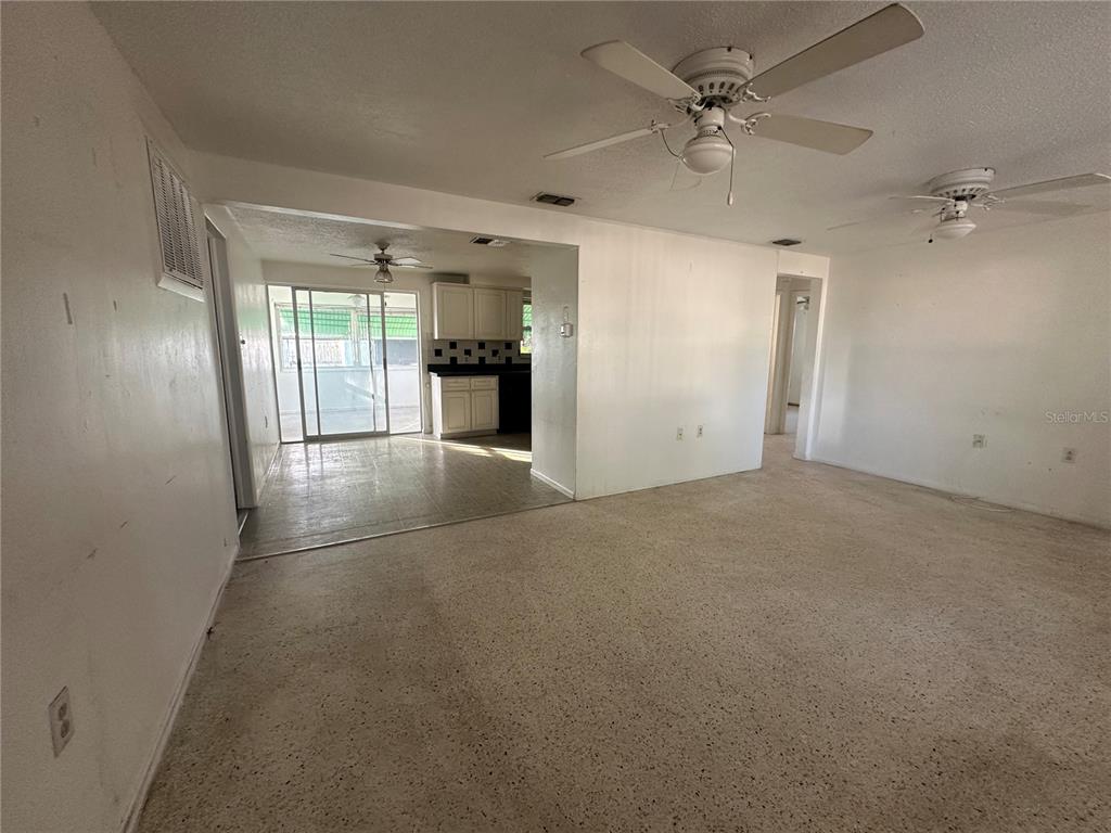 3505 Latimer Street New Port Richey, FL 34652 - Photo 4 of 20 an empty room with chandelier fan and windows