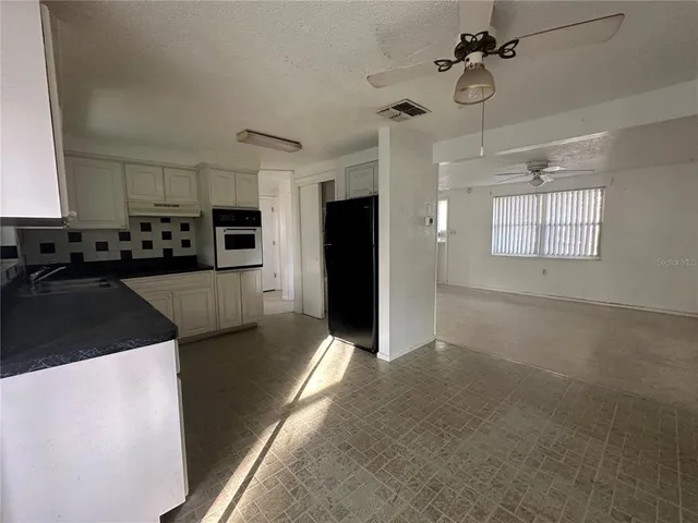 a view of a kitchen with a sink and dishwasher stove top oven