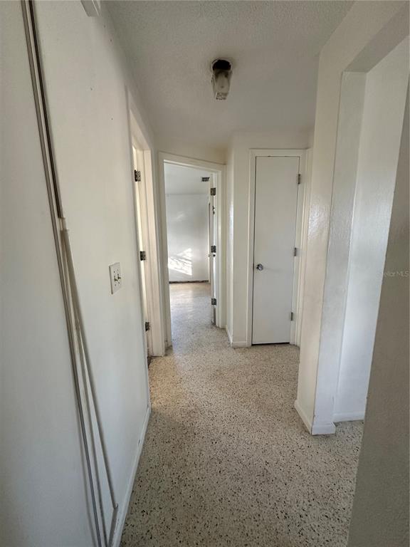 3505 Latimer Street New Port Richey, FL 34652 - Photo 8 of 20 a view of a hallway with wooden shelves
