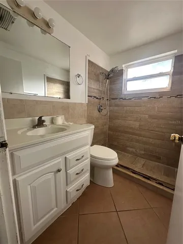 a bathroom with a sink a toilet and mirror
