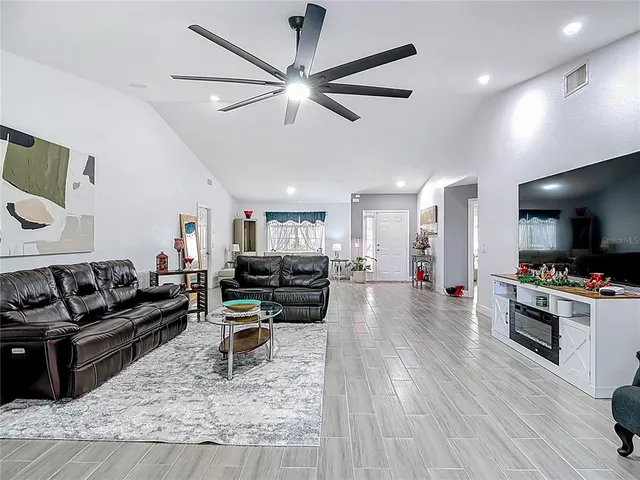 a living room with furniture and kitchen view