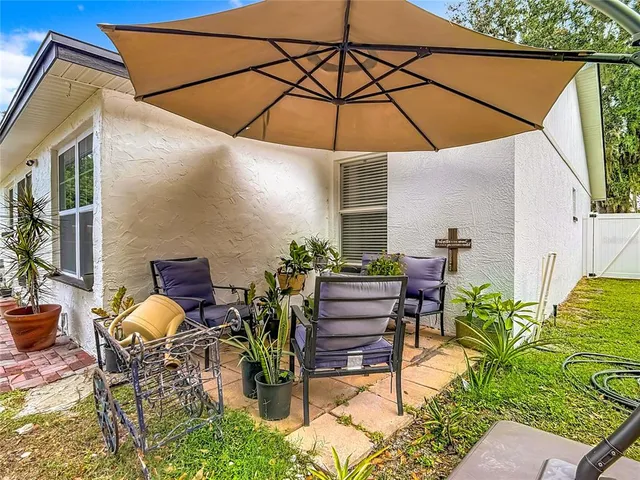 a patio with a patio table and chairs