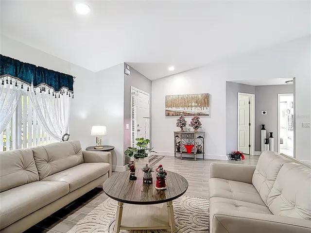 a living room with furniture and a large mirror
