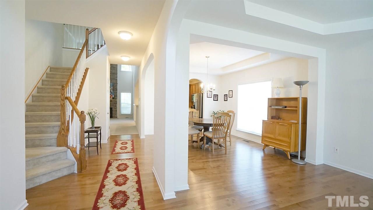 3030 Kilarney Ridge Loop Cary, NC 27511 - Photo 2 of 30 *Entry Foyer Looking into Living Areas*Living Room to the Right*Dining Room*Family Room in the Distance*Hardwood Floors in Entry, Dining and Living Rm*
