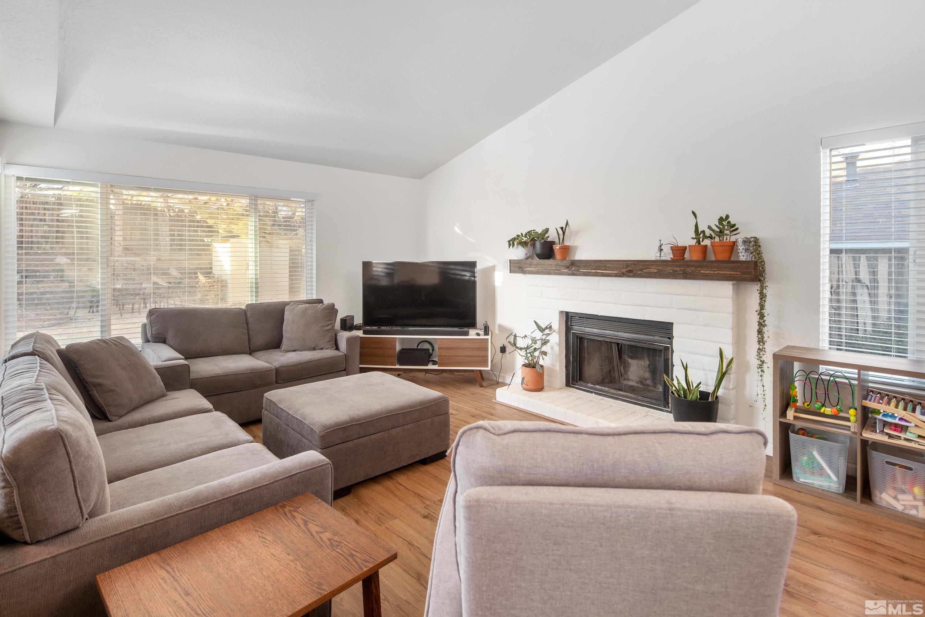 1195 Westlake Road Reno, NV 89523 - Photo 6 of 28 a living room with furniture a flat screen tv and a fireplace