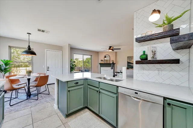 a kitchen with a sink and a stove top oven