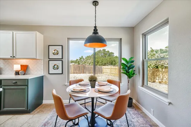 a dining room with furniture a window and a chandelier