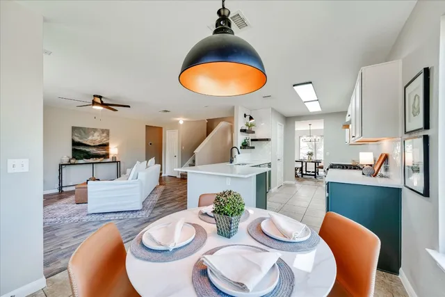 a dining room with furniture and a wooden floor