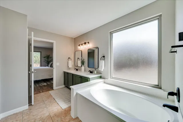 a en suite bathroom with a sink and mirror