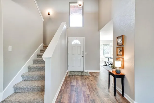 a view of entryway and hall with wooden floor