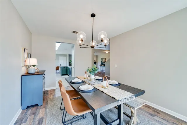 a view of a dining room with furniture wooden floor and chandelier