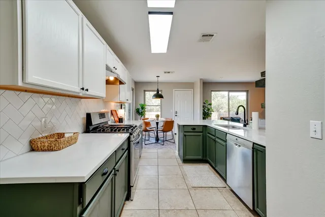 a kitchen with a sink a stove and chairs