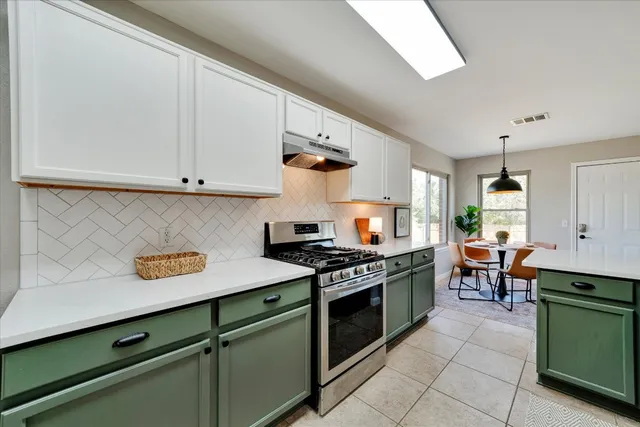 a kitchen with stainless steel appliances granite countertop a stove and a cabinets