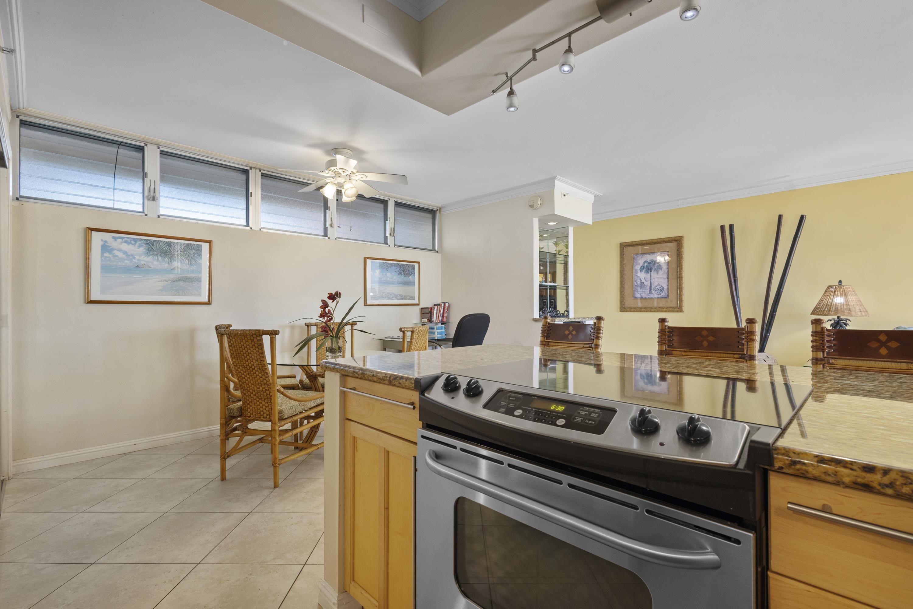 4365 Lower Honoapiilani Road, Unit 115 Lahaina, HI 96761 - Photo 12 of 44 a view of a dining room with furniture and a chandelier