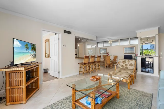 a living room with furniture a flat screen tv and wooden floor